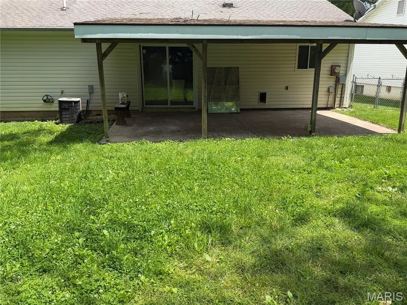 Covered concrete patio with sliding glass door access — 2505 Ambelwood Lane, O'Fallon, MO 63368