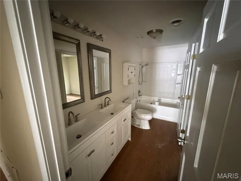 Double vanity with undermount sinks, wall-mounted mirrors, and chrome fixtures — 2505 Ambelwood Lane, O'Fallon, MO 63368