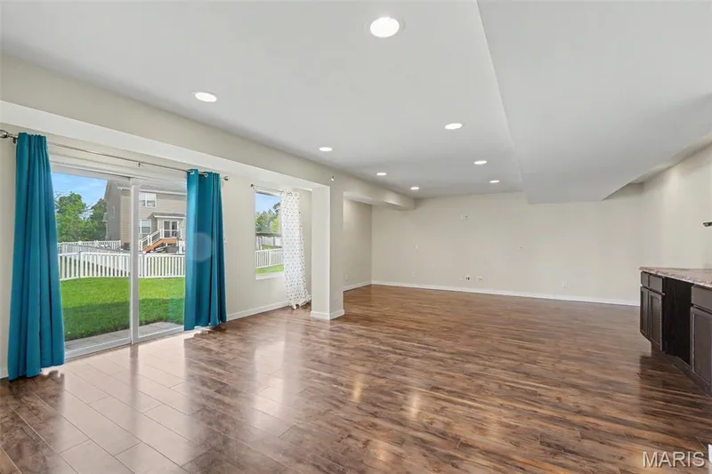 Large, open lower-level family/rec room with LVP flooring and a convenient kitchenette — 18 Sonnet Way Court, Wentzville, MO 63385