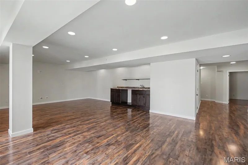 Large, open lower-level family/rec room with LVP flooring and a convenient kitchenette — 18 Sonnet Way Court, Wentzville, MO 63385