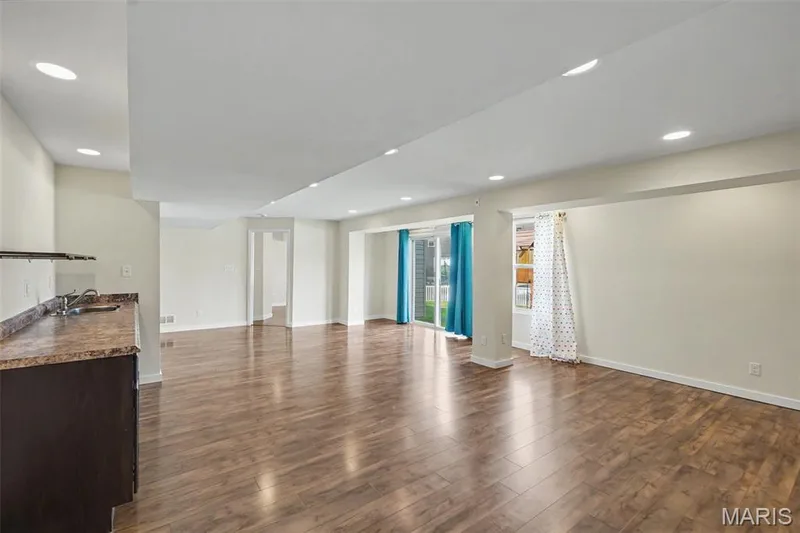 Large, open lower-level family/rec room with LVP flooring and a convenient kitchenette — 18 Sonnet Way Court, Wentzville, MO 63385