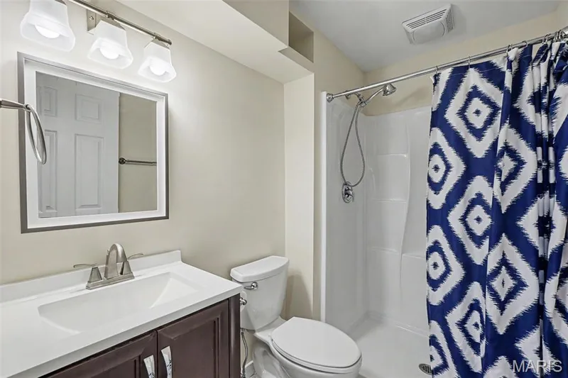 Lower-level 3rd bathroom featuring ceramic tile flooring and an elongated commode — 18 Sonnet Way Court, Wentzville, MO 63385