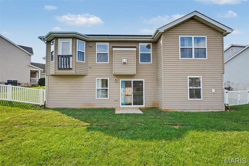Rear facade featuring a walk-out to a large, level backyard — 18 Sonnet Way Court, Wentzville, MO 63385