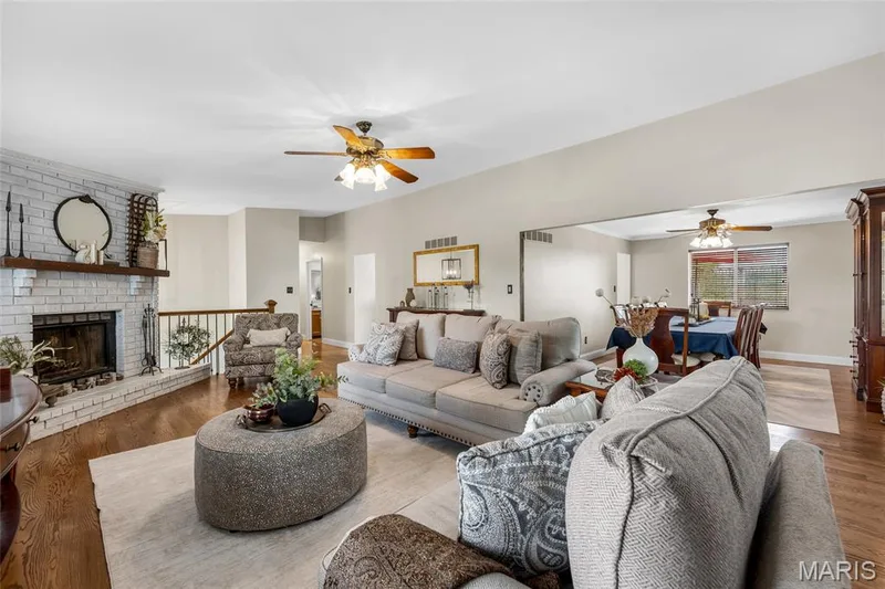 Enjoy the warmth and elegance of 3/4" solid oak flooring, wood burning fireplace, vaulted ceiling & adjoining dining room — 16 La Rochelle Court, Lake St. Louis, MO 63367