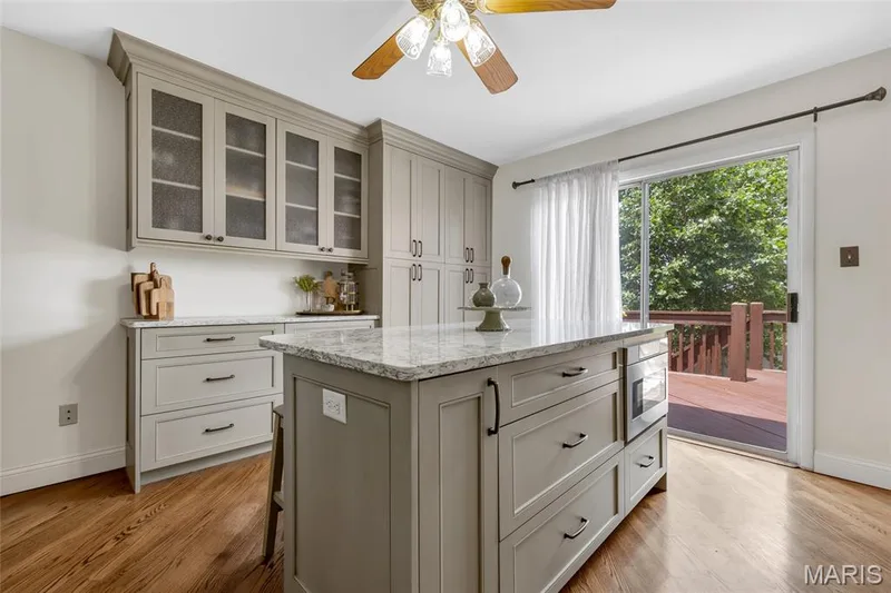 Kitchen island and walk out to deck — 16 La Rochelle Court, Lake St. Louis, MO 63367