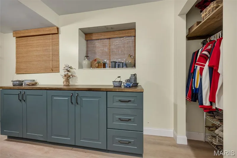 Laundry is less of a chore with new cabinetry featuring butcher block countertop, 2 closets, storage shelves & a handy appliance charging  station! — 16 La Rochelle Court, Lake St. Louis, MO 63367