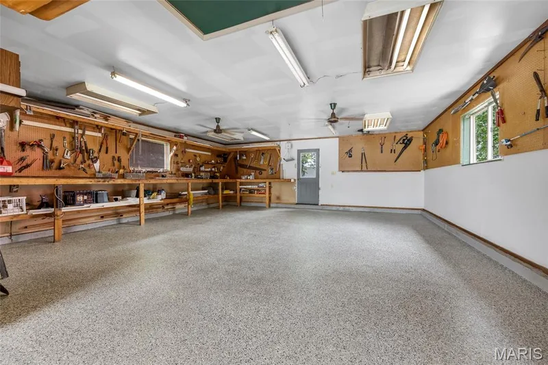 Dream workshop includes attic storage, yards of pegboard and a fantastic workbench! easy access to back yard. — 16 La Rochelle Court, Lake St. Louis, MO 63367
