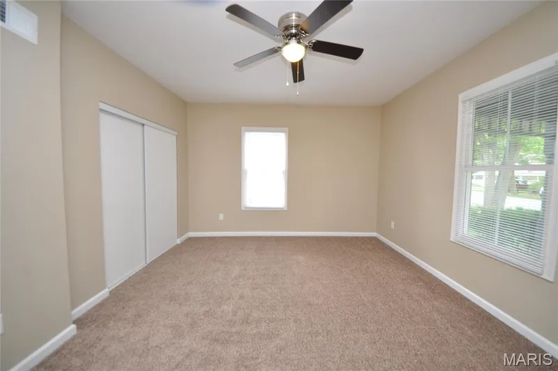 Room with neutral-toned walls and brown carpet flooring — 502 S Linn Avenue, Wentzville, MO 63385