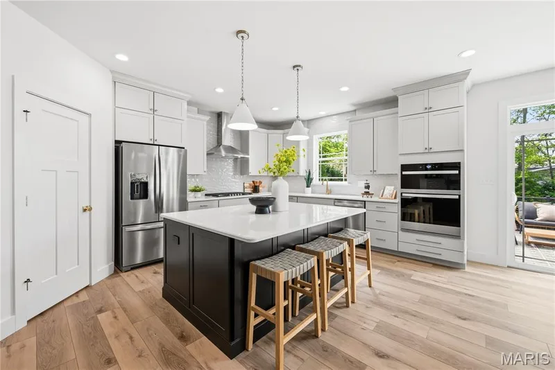 On-Trend Kitchen with 42 inch Frost Cabinets with Crown and Contrasting Island with Seating Bar — 527 Ryehill Drive, St Peters, MO 63376
