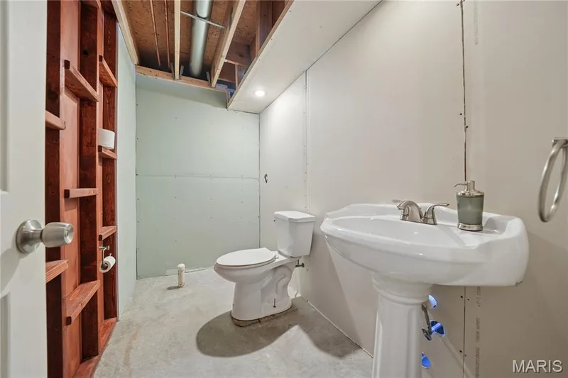 Lower level half bath with pedestal sink and rough in for shower.  Ready to be completed. — 814 Emerald Place Drive, St Charles, MO 63304