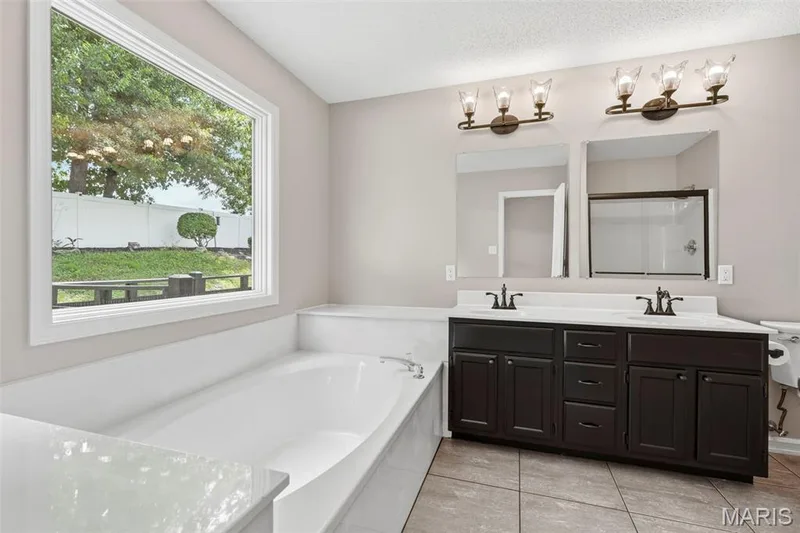 Soaking tub with a large picture window — 814 Emerald Place Drive, St Charles, MO 63304