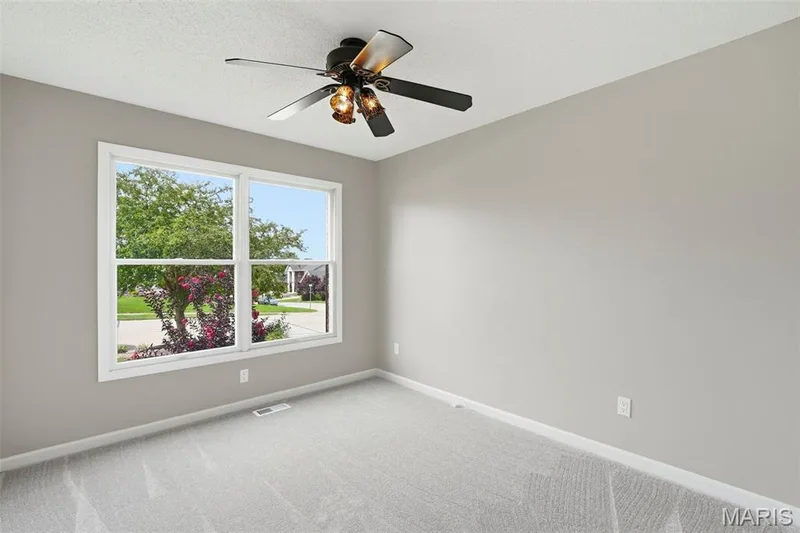 Neutral wall color, wall-to-wall carpeting, white trim, and a ceiling fan with integrated lighting — 814 Emerald Place Drive, St Charles, MO 63304