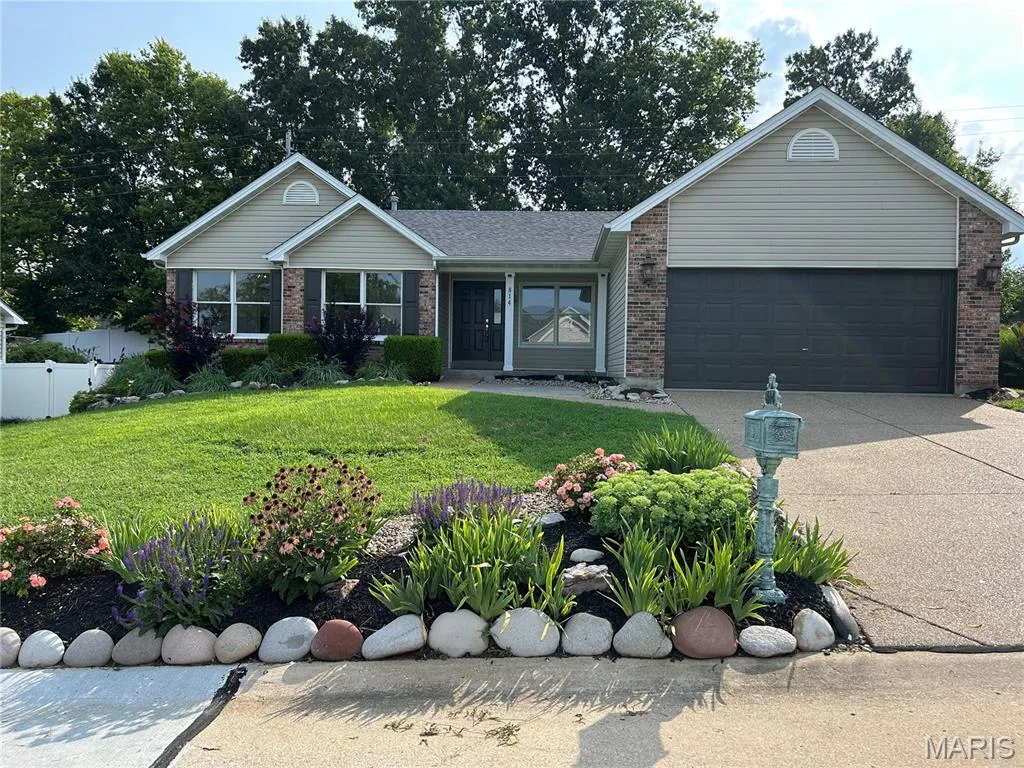 Professionally landscaped ranch featuring brick and siding exterior, an attached 2 car garage, and a concrete driveway — 814 Emerald Place Drive, St Charles, MO 63304