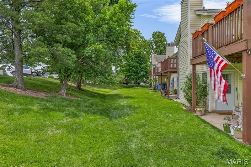 Expansive grassy area bordered by mature trees — 1034 Windstream Drive #14, St Peters, MO 63376