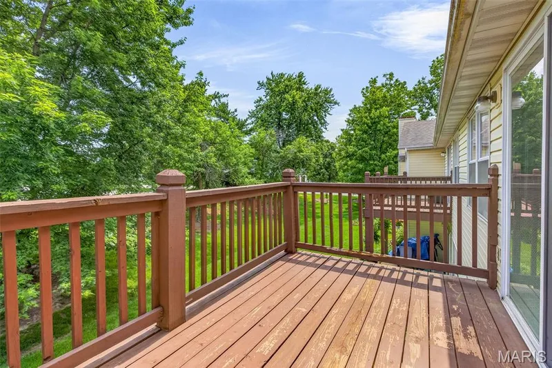 Spacious wooden deck featuring a full railing system — 1034 Windstream Drive #14, St Peters, MO 63376