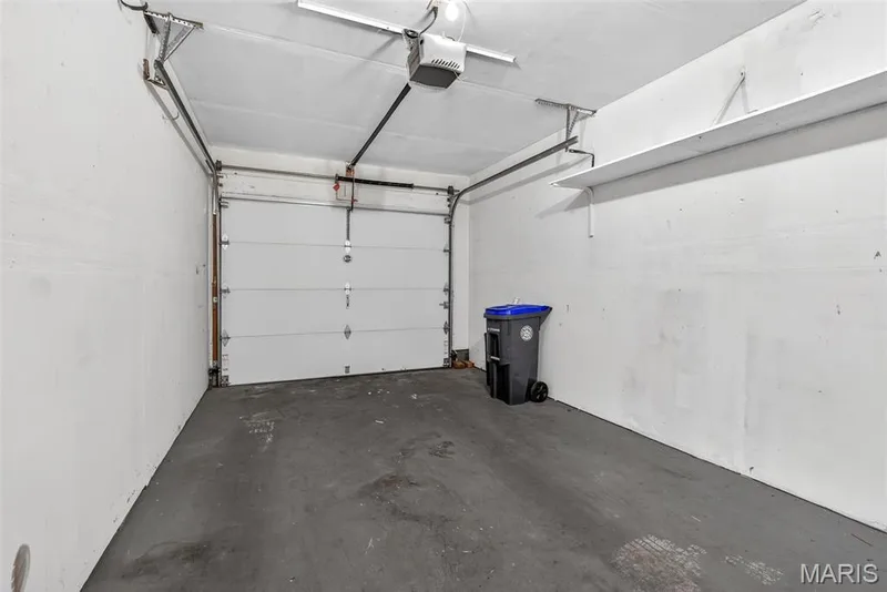 Attached garage featuring a white overhead door and automatic opener — 1034 Windstream Drive #14, St Peters, MO 63376