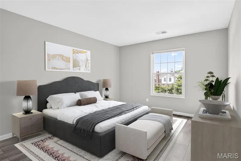 Bedroom featuring light gray walls, a window with grid panes, wood-finish flooring, and white trim — 1034 Windstream Drive #14, St Peters, MO 63376