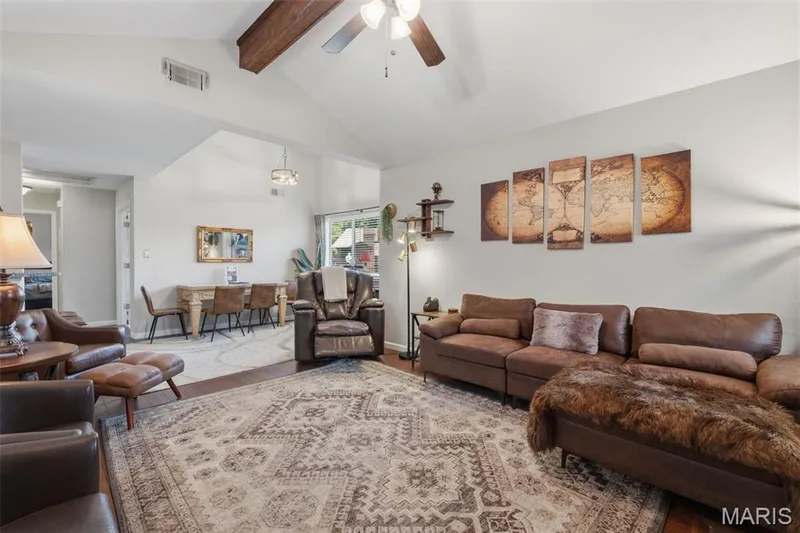 Vaulted ceiling with wood-finish beam, hardwood flooring, ceiling fan, and recessed lighting — 704 Hemingway Lane #E, Weldon Spring, MO 63304