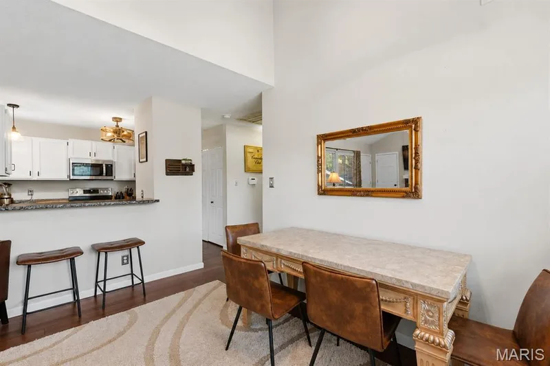 Open-concept dining area with a breakfast bar — 704 Hemingway Lane #E, Weldon Spring, MO 63304