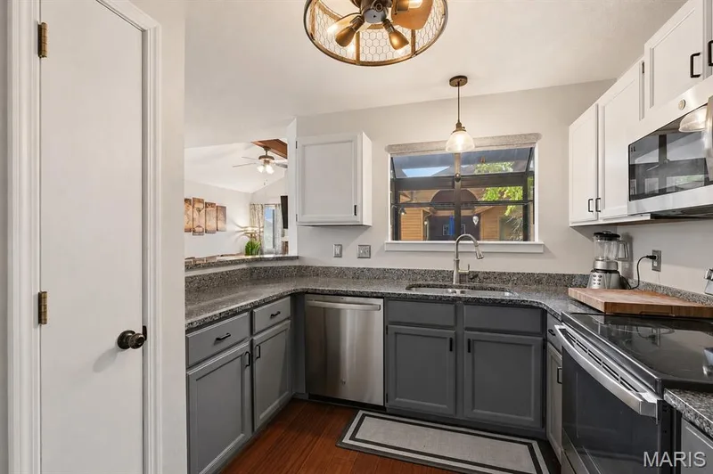 Kitchen featuring a U-shaped countertop and pantry — 704 Hemingway Lane #E, Weldon Spring, MO 63304