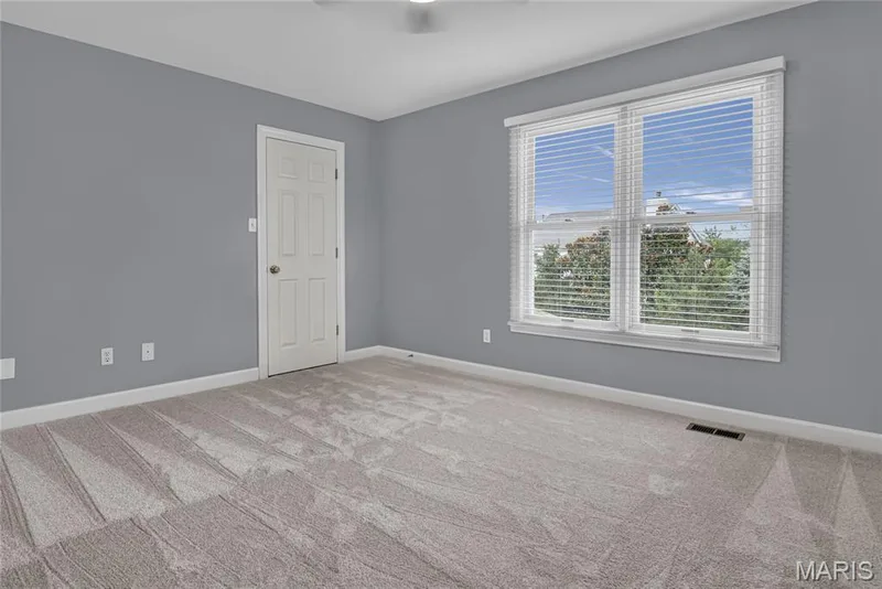 2nd Ensuite Bedroom upstairs with Neutral gray wall paint, light-toned carpeting, white trim, and a double window with blinds — 2154 White Lane Drive, Chesterfield, MO 63017