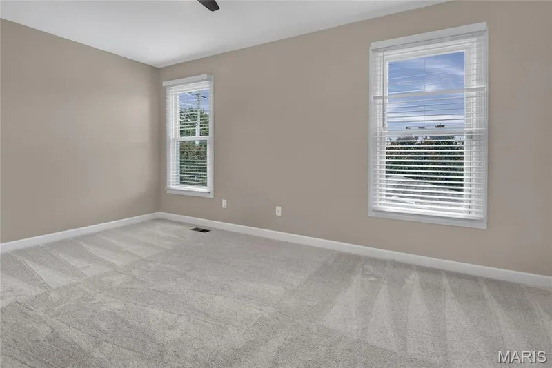 3rd Bedroom with Jack-n-Jill Bathroom. Neutral wall color, light-toned carpet flooring, and two windows with white blinds — 2154 White Lane Drive, Chesterfield, MO 63017