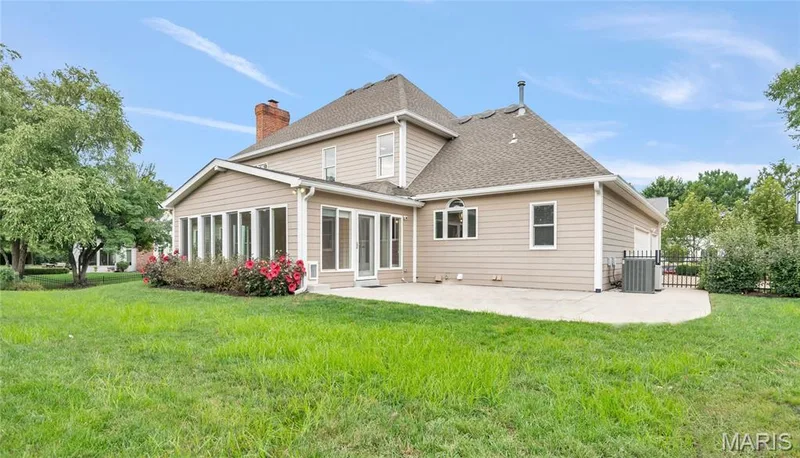 sunroom with numerous windows, concrete patio, and a side-gabled roof — 2154 White Lane Drive, Chesterfield, MO 63017