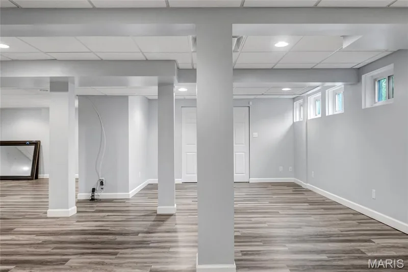 Expansive room featuring wood-finish flooring, recessed lighting, and multiple windows — 2154 White Lane Drive, Chesterfield, MO 63017