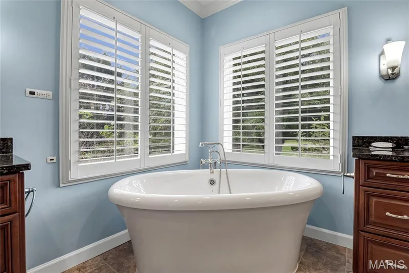 Freestanding soaking tub with heated flooring  and timeless plantation shutters — 2154 White Lane Drive, Chesterfield, MO 63017