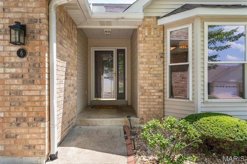 Covered front entry porch of brick villa. — 6 Country Bluff Court, St Charles, MO 63301
