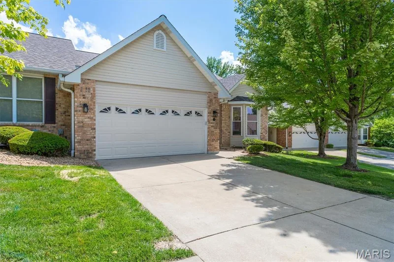 Two-car attached garage has double-pad parking pad. — 6 Country Bluff Court, St Charles, MO 63301