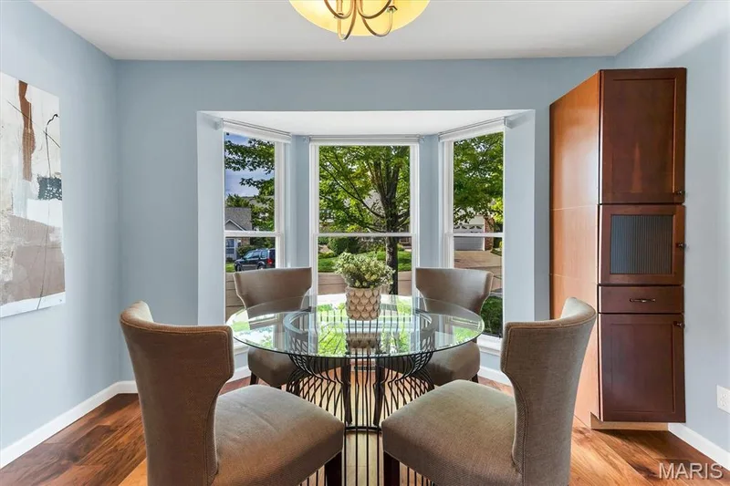 Breakfast room has bay window and custom built-in cabinet. — 6 Country Bluff Court, St Charles, MO 63301