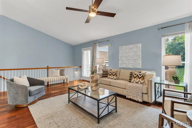 Living room with oversized windows & ceiling fan. — 6 Country Bluff Court, St Charles, MO 63301