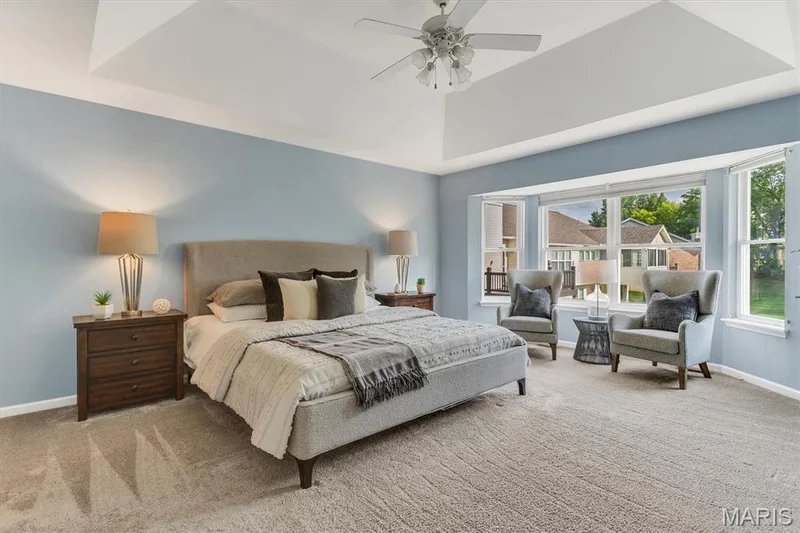 Main floor primary bedroom has private full bath & deep walk-in closet and bow window opening to nice common ground view. — 6 Country Bluff Court, St Charles, MO 63301