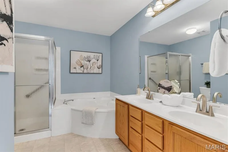 Primary bath has separate shower & jet tub and dual sinks. — 6 Country Bluff Court, St Charles, MO 63301