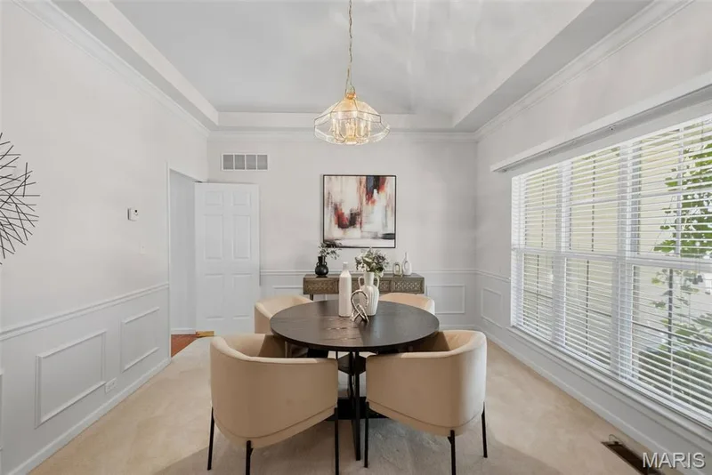 Formal Dining room with decorative wainscoting & crown molding — 202 Highland Meadows Drive, Wentzville, MO 63385