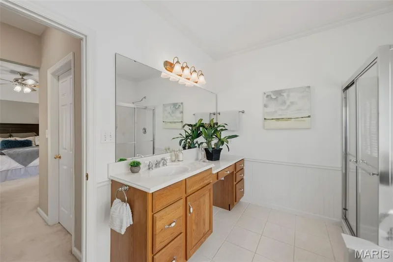 Primary en-suite bath with shower & separate soaking tub, built in vanity, & finished off with crown molding — 202 Highland Meadows Drive, Wentzville, MO 63385