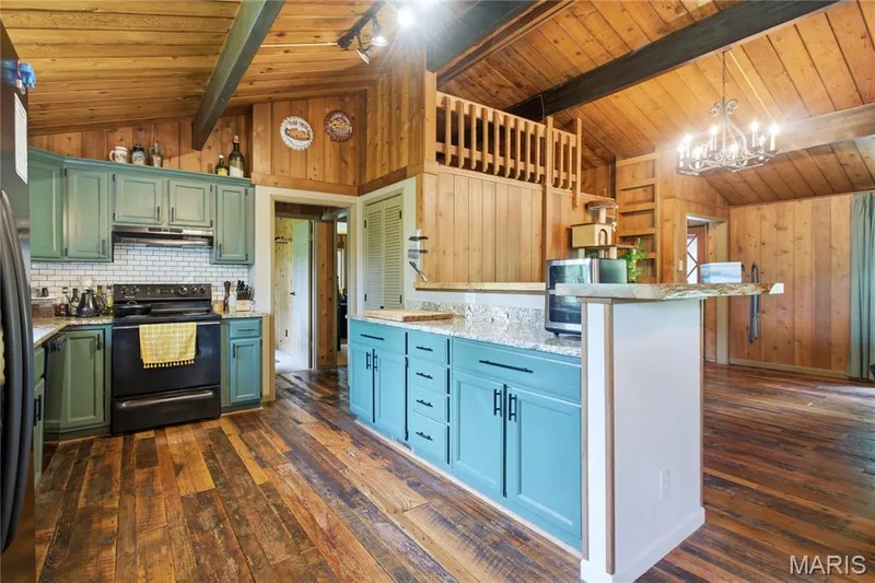 Kitchen featuring painted cabinetry, subway tile backsplash, and light-toned countertops — 1221 Shepard Road, Wildwood, MO 63038