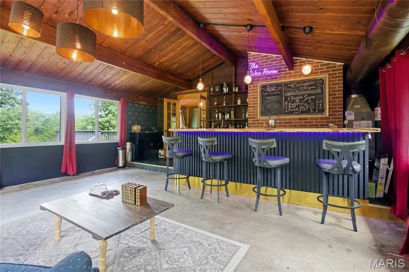 Custom bar area featuring exposed brick, wood-paneled vaulted ceiling, and built-in shelving — 1221 Shepard Road, Wildwood, MO 63038