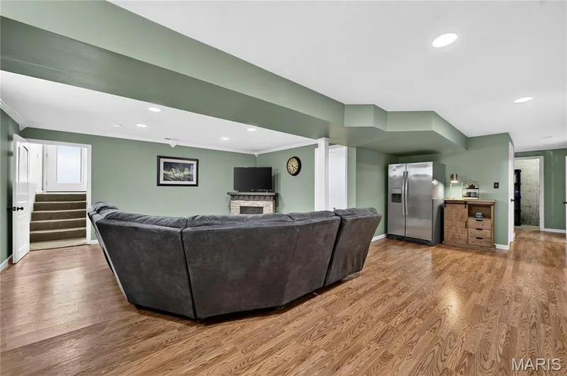 Spacious recreational area featuring wood-finish flooring, recessed lighting. — 708 Bellingrath Gardens Court, Wentzville, MO 63385