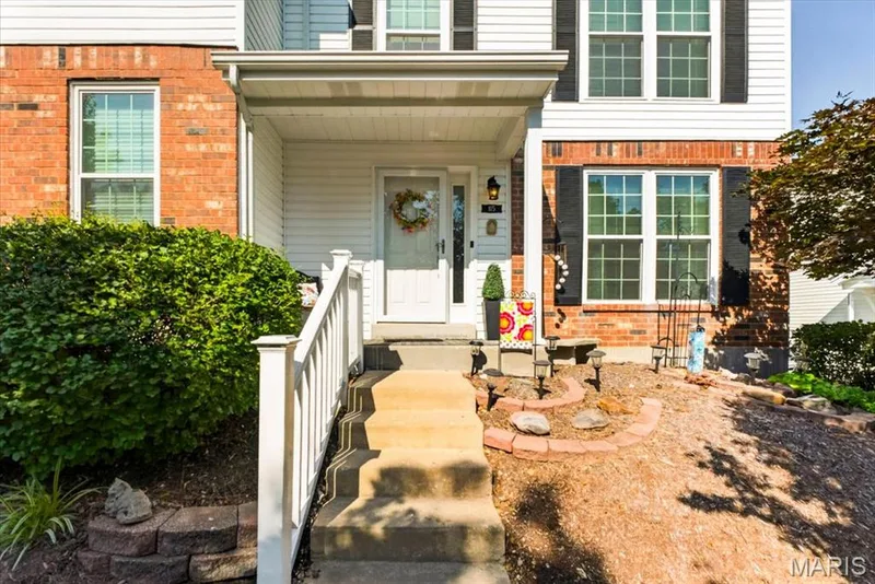 Exterior showcasing brick and siding construction with black louvered shutters — 115 Carriage View Drive, Wildwood, MO 63040