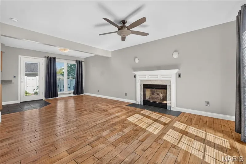 Living area featuring wood-finish flooring and a ceiling fan — 115 Carriage View Drive, Wildwood, MO 63040
