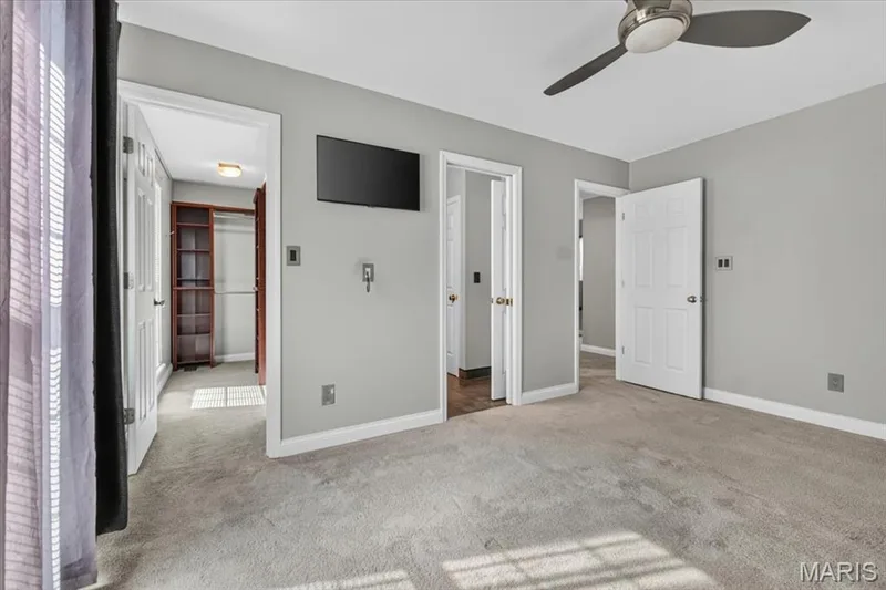 Spacious room featuring neutral carpeting, light gray wall paint, and white trim — 115 Carriage View Drive, Wildwood, MO 63040
