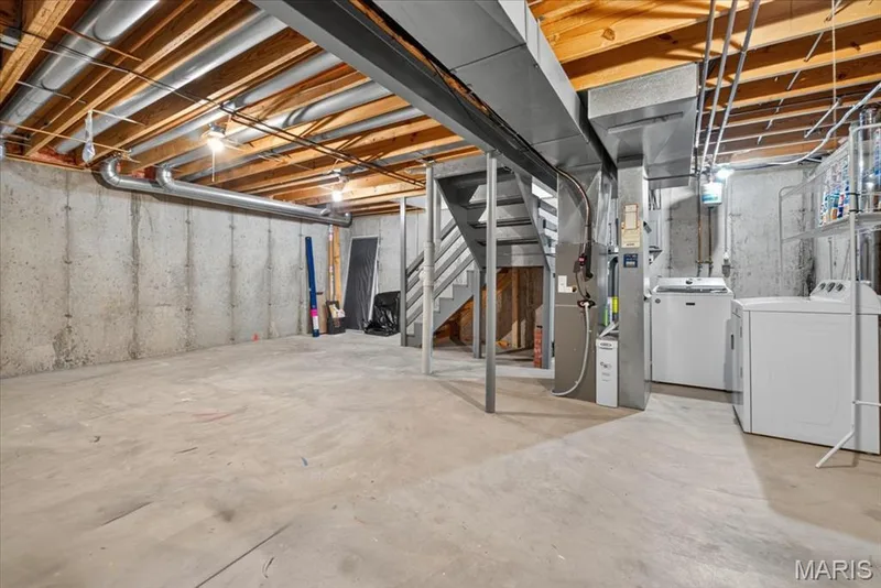 Unfinished basement offering concrete flooring, exposed wood ceiling joists, and concrete foundation walls — 115 Carriage View Drive, Wildwood, MO 63040