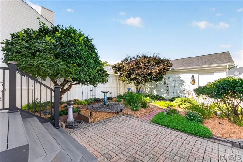 Brick paver patio with a composite deck entry — 115 Carriage View Drive, Wildwood, MO 63040
