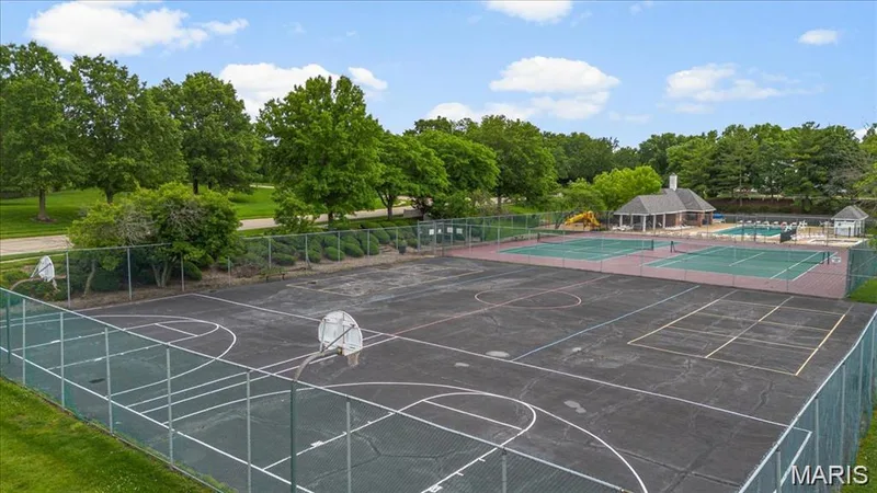 Recreational complex featuring multiple tennis courts, a basketball court, and an outdoor swimming pool area with a clubhouse building — 115 Carriage View Drive, Wildwood, MO 63040