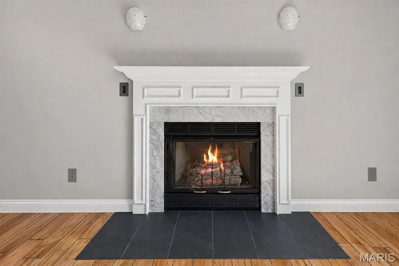 Fireplace with a white mantel and marble surround — 115 Carriage View Drive, Wildwood, MO 63040