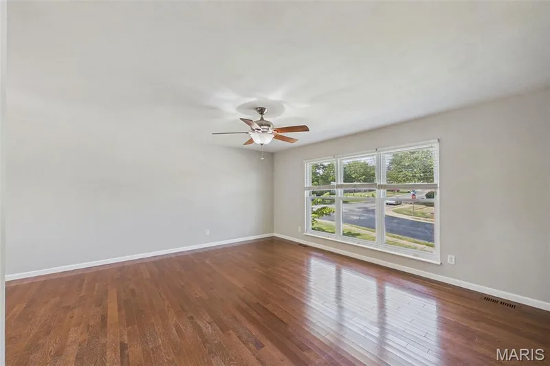 The living room is spacious with three large floor to ceiling windows in front. — 656 Nancy Drive, St Charles, MO 63301
