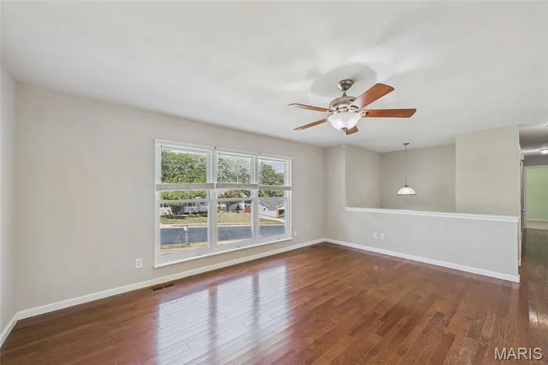 The living room is large and welcoming, with fresh paint and a ceiling fan — 656 Nancy Drive, St Charles, MO 63301