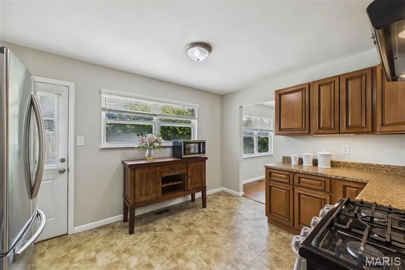 The eat-in kitchen has great windows for natural light and access to the backyard patio — 656 Nancy Drive, St Charles, MO 63301